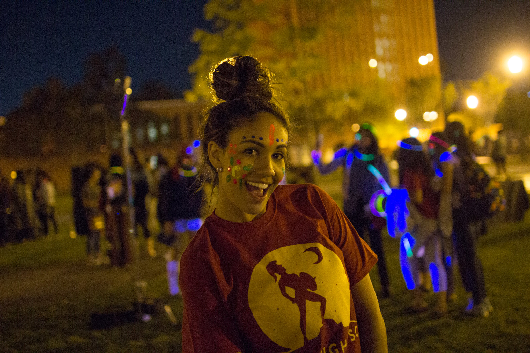 student smiling with painted face at Conquest event