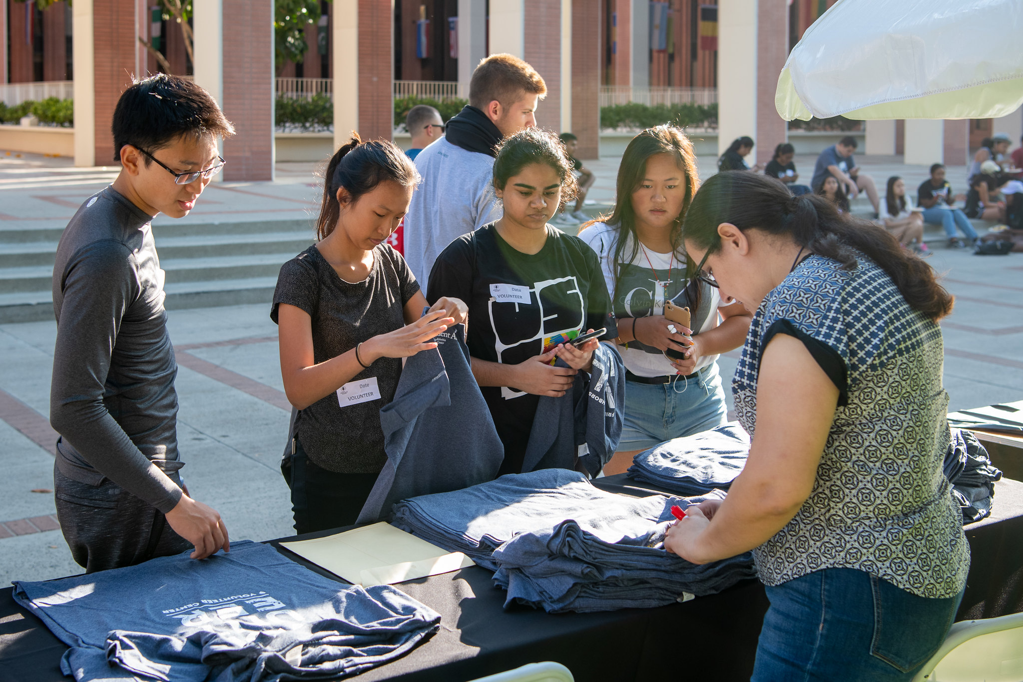 students buying t-shirts at table