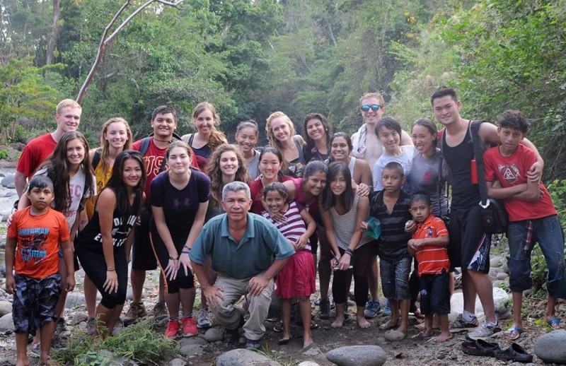 students posed with children in Guatemalan jungle